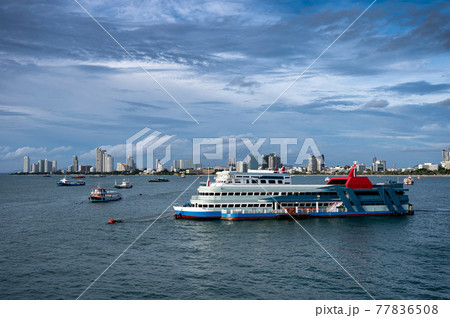 Ferry boat floating on tropical sea and buildings downtown on coastline Ferry boat floating on tropical sea and buildings downtown on coastline 77836508