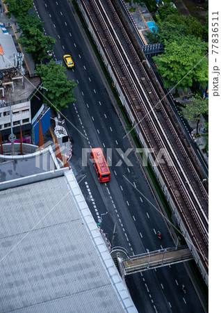 Public bus driving on highway and skytrain railway in Bangkok 77836511