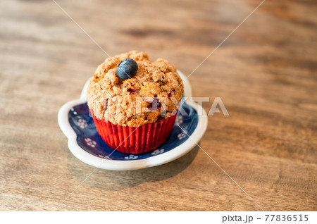 Homemade baked blueberry muffin on wooden table Homemade baked blueberry muffin on wooden table 77836515