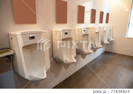 Row of urinal with signboard in toilet 77836824