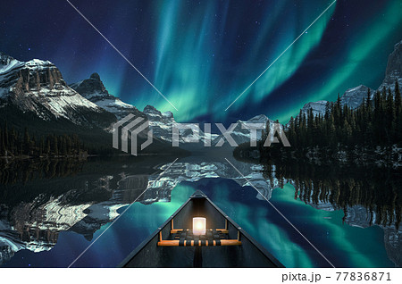 Canoeing with Aurora Borealis over mountain range in Maligne Lake at Jasper national park Canoeing with Aurora Borealis over mountain range in Maligne Lake at Jasper national park 77836871