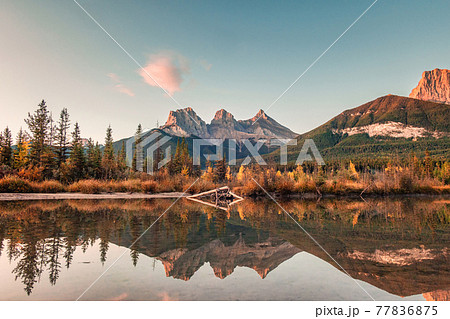 Three sisters mountains of rocky mountains reflection on bow river in the morning at Canmore, Banff national park 77836875