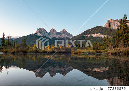 Three sisters mountains of rocky mountains reflection on bow river in the morning at Canmore, Banff national park Three sisters mountains of rocky mountains reflection on bow river in the morning at Canmore, Banff national park 77836876