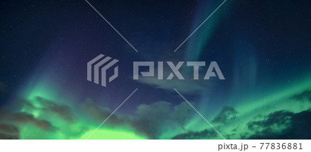 Aurora Borealis or Northern Lights with starry glowing in the night sky 77836881