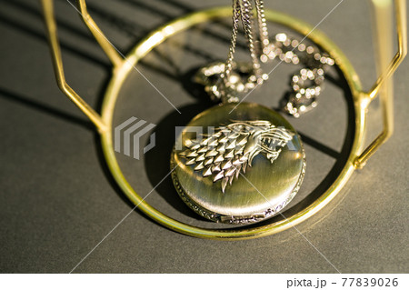 Pocket watch with a wolf head design closeup. Selective Focus Pocket watch with a wolf head design closeup. Selective Focus 77839026