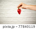 Ripe juicy red beautiful strawberry close-up is an appetizing fresh snack 77840119