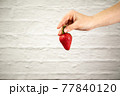 Ripe juicy red beautiful strawberry close-up is an appetizing fresh snack 77840120