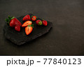Ripe juicy red beautiful strawberry close-up is an appetizing fresh snack 77840123