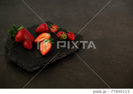 Ripe juicy red beautiful strawberry close-up is an appetizing fresh snack Ripe juicy red beautiful strawberry close-up is an appetizing fresh snack 77840123