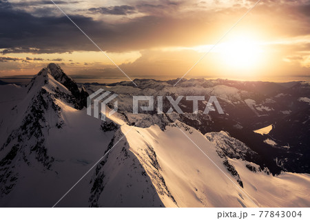 Aerial View from Airplane of Blue Snow Covered Canadian Mountain Landscape 77843004