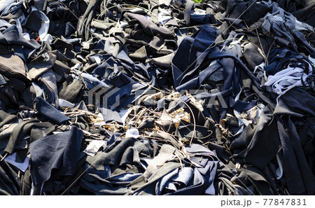 Collage of various textile scraps. Production of fashion items yields tonnes of cut up pieces of fabric which can be re-purposed further in the industry. 77847831