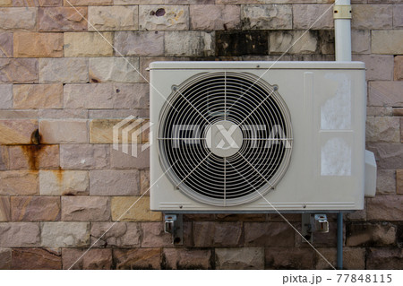 air compressor on the brick wall 77848115