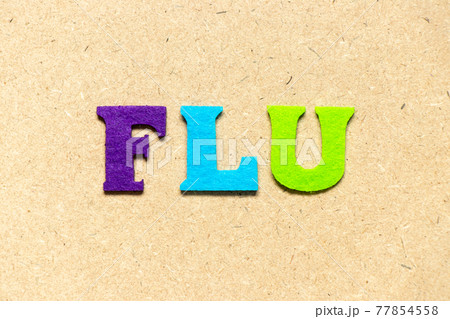 Color cloth alphabet letter in word flu on wood background 77854558