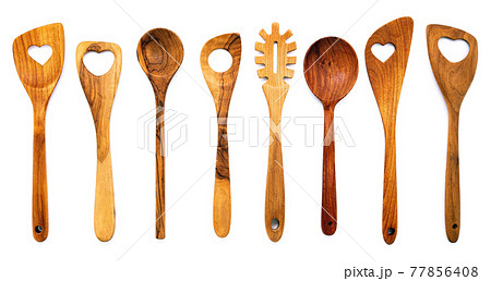 Various heart shape of wooden cooking utensils. Wooden spoons and wooden spatula isolate on white background. 77856408