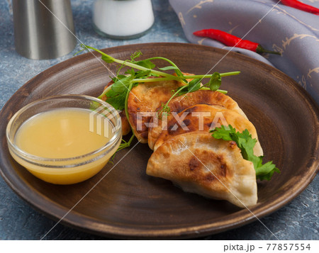 small meat pies posikunchiki with mustard sauce. Russian cuisine small meat pies posikunchiki with mustard sauce. Russian cuisine 77857554