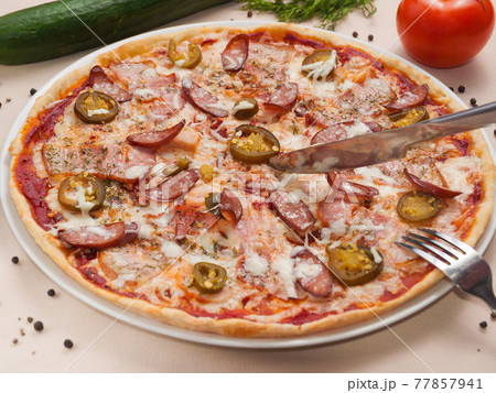 spicy pizza with sausage meat and jalapeno 77857941