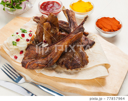 lamb loin on pita bread with onion and pomegranate seeds lamb loin on pita bread with onion and pomegranate seeds 77857964