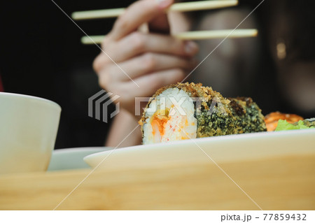 Japanese kitchen. Set of Japanese sushi and rolls. Food sticks. Japanese kitchen. Set of Japanese sushi and rolls. Food sticks. 77859432