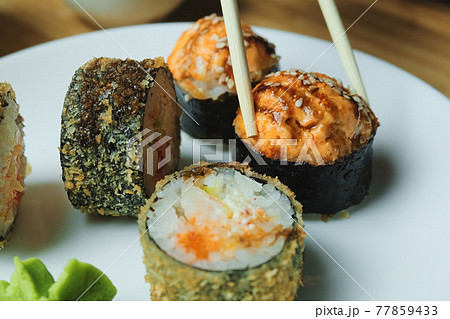 Japanese kitchen. Set of Japanese sushi and rolls. Food sticks. Japanese kitchen. Set of Japanese sushi and rolls. Food sticks. 77859433