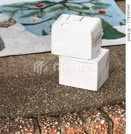 Two white packages left on front stoop 77859544