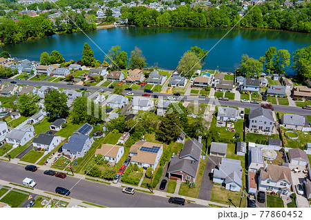 Wide panorama, aerial view with tall single home, in the beautiful residential quarters Sayreville town near pond New Jersey US Wide panorama, aerial view with tall single home, in the beautiful residential quarters Sayreville town near pond New Jersey US 77860452