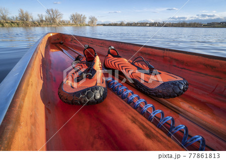 water shoes on a deck of a stand up paddleboard water shoes on a deck of a stand up paddleboard 77861813