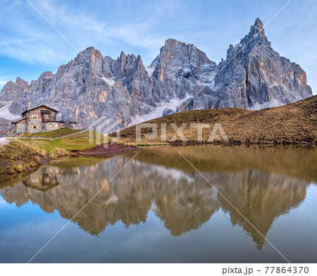 Evening twilight autumn alpine Dolomites mountain scene, Trento, Italy. Lake or Laghetto Baita Segantini view. Evening twilight autumn alpine Dolomites mountain scene, Trento, Italy. Lake or Laghetto Baita Segantini view. 77864370