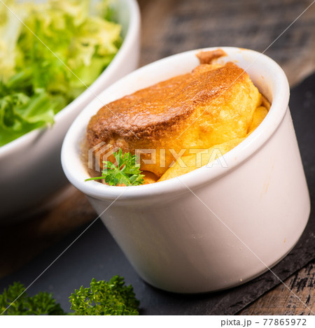 Cheese egg souffle on rustic cloth on a wooden background Cheese egg souffle on rustic cloth on a wooden background 77865972