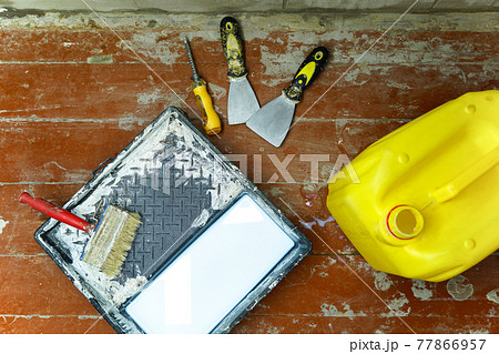 Construction and painting tools lie on the floor during the repair and restoration of the house.Work as a Builder or handyman in the house.Finishing or repairing a room.Job of repairing the apartment 77866957