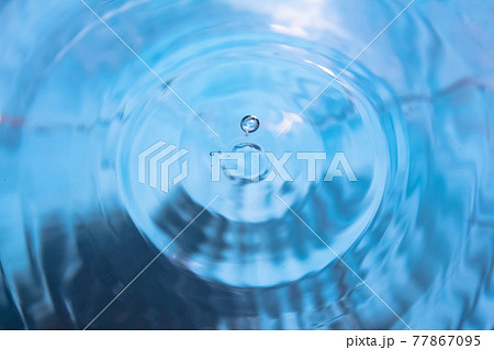 Water splash close-up. Crown of blue water. Water drop 77867095