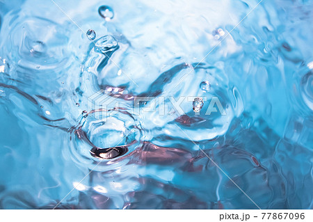 Water splash close-up. Crown of blue water. Water drop 77867096