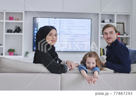 Happy Muslim family spending time together in modern home Happy Muslim family spending time together in modern home 77867293