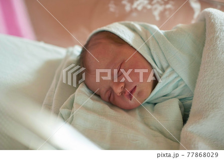 newborn baby sleeping in bed at hospital newborn baby sleeping in bed at hospital 77868029