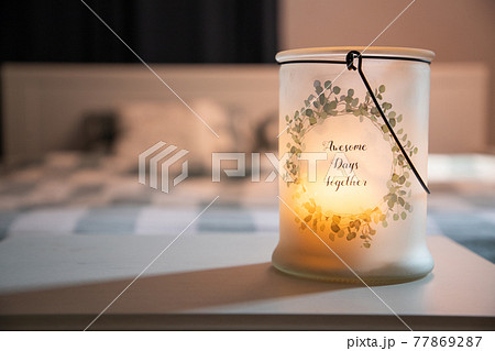 cozy bedroom detail focus on burning candle cozy bedroom detail focus on burning candle 77869287