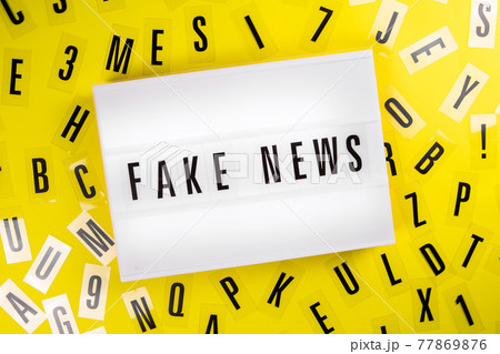 Lightbox with message FAKE NEWS on yellow background letters aroung, big lie Lightbox with message FAKE NEWS on yellow background letters aroung, big lie 77869876
