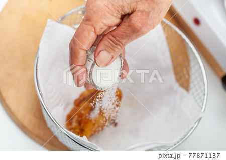 Senior woman preparing a traditional dish from el Valle del Cauca in Colombia called aborrajado 77871137