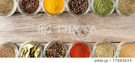 Colourful seasonings in bowls on wooden background with copyspace. Collection of spices. Panoramic banner Colourful seasonings in bowls on wooden background with copyspace. Collection of spices. Panoramic banner 77883634