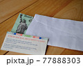The US federal stimulus check showing the statue of liberty with envelop next to social security card. People with SSN receive the Covid 19 pandemic Economic Impact Payments. Relief Program concept.  77888303