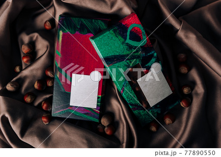 Chocolate packaging on a crumpled satin fabric 77890550