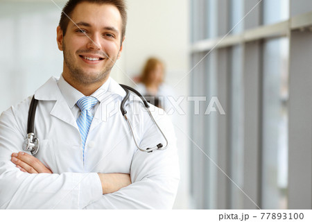 Male dark hair doctor standing in the modern clinic. Perfect medical service in the hospital. Medicine concept 77893100