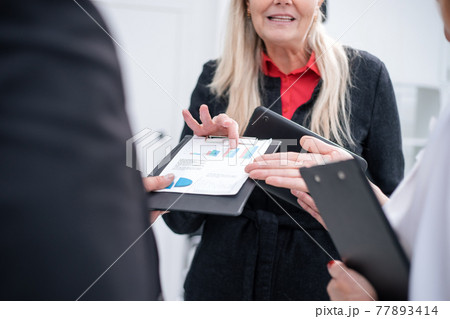 close up. group of employees discussing financial schedules close up. group of employees discussing financial schedules 77893414