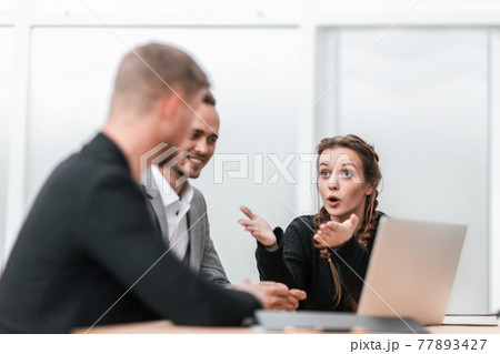 young business colleagues sitting at the office Desk 77893427