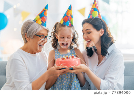 Grandmother, mother and daughter are celebrating birthday. 77894000