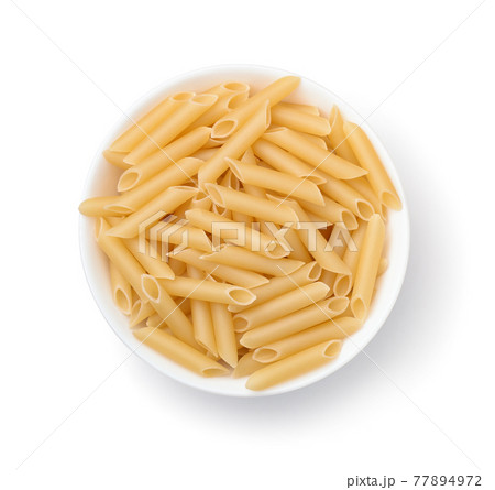 Top view of uncooked penne lisce pasta in bowl Top view of uncooked penne lisce pasta in bowl 77894972