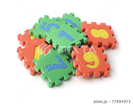 Pile of colorful foam math numbers puzzle pieces Pile of colorful foam math numbers puzzle pieces 77894973