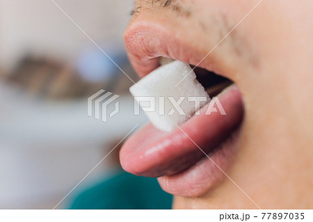 Man and sugar. Calories. Sugar free. tongue close-up. Man and sugar. Calories. Sugar free. tongue close-up. 77897035
