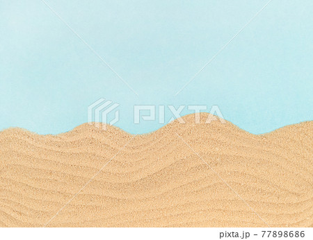 Sand waves on blue paper with copy space. Sand waves on blue paper with copy space. 77898686