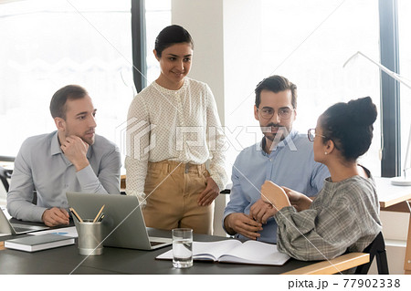 Diverse colleagues listening to African American businesswoman, brainstorming at briefing 77902338