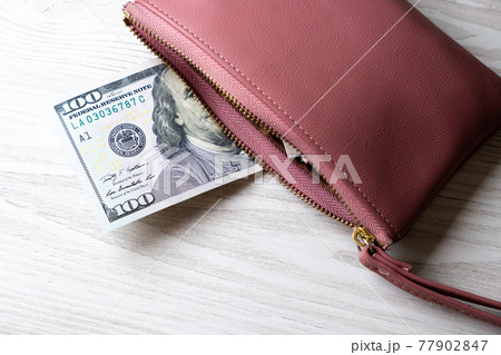 pink wallet with a hundred dollar bill and a lot of money. Finance, expenses and income concept  77902847