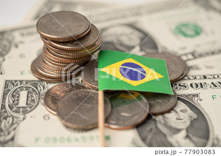 Stack of coins with Brazil flag on USA America dollar banknotes. 77903083